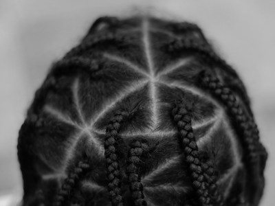 https://unsplash.com/photos/ptyj_QoPRsQ [ID: A close-up photograph of the back of a persons head, gives us a look into the triangular box braids that cover their scalp. The picture is in black and white.]
