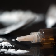 Close up of drug syringe and cooked heroin