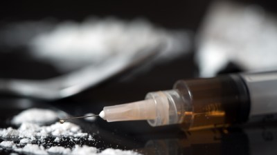 Close up of drug syringe and cooked heroin